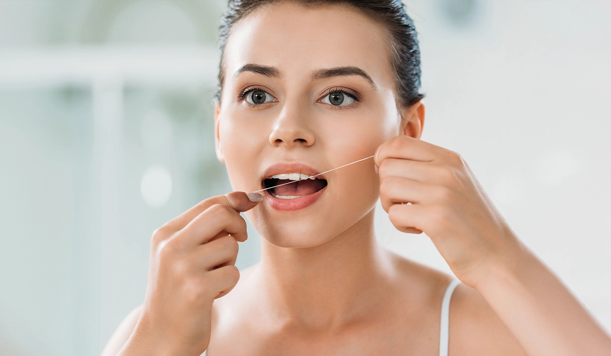 leeming-dental-blog-Why you can't afford to ignore gaps in your smile - woman flossing Why you can't afford to ignore gaps in your smile